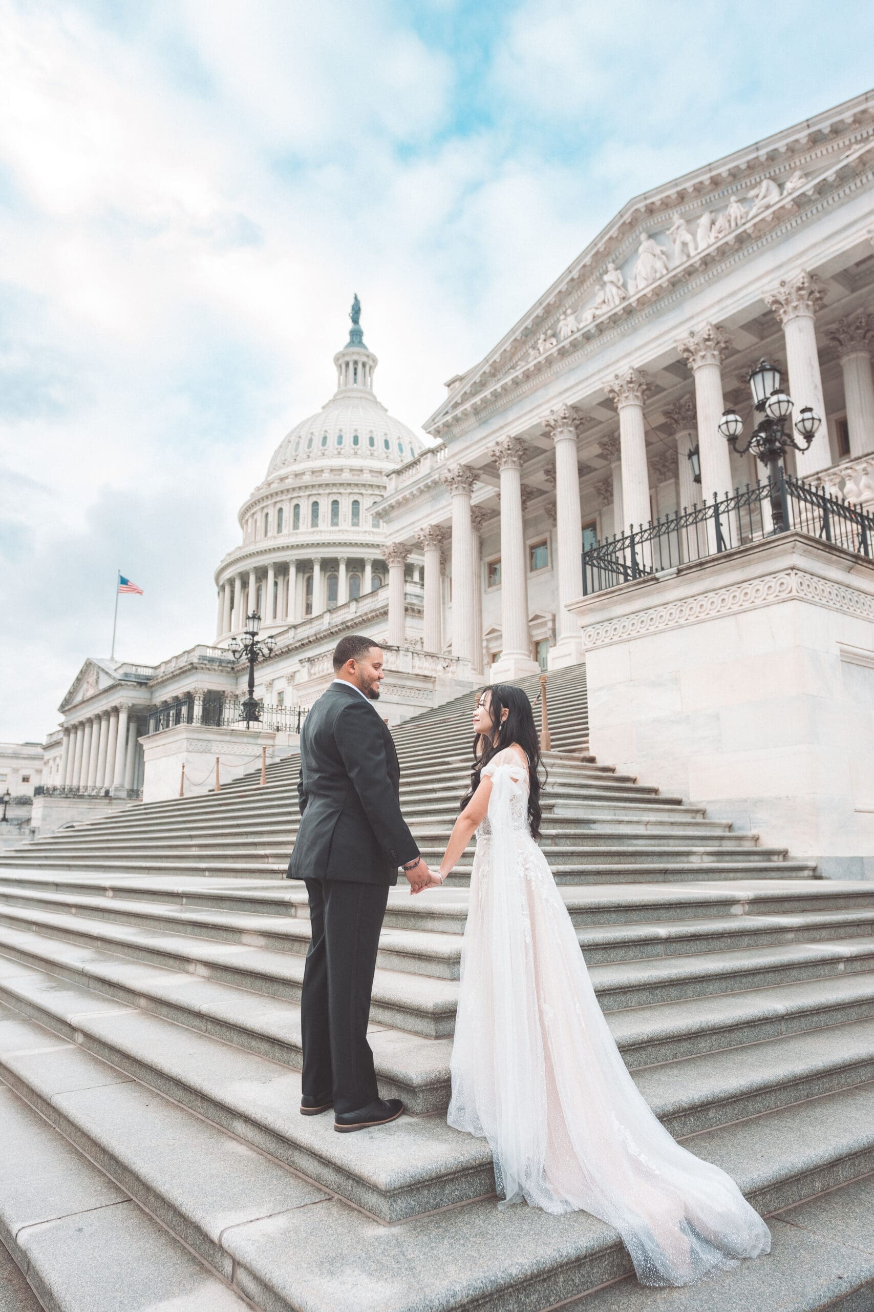Couple holding hands on the steps of the U.S. Capitol during a romantic Washington DC engagement session