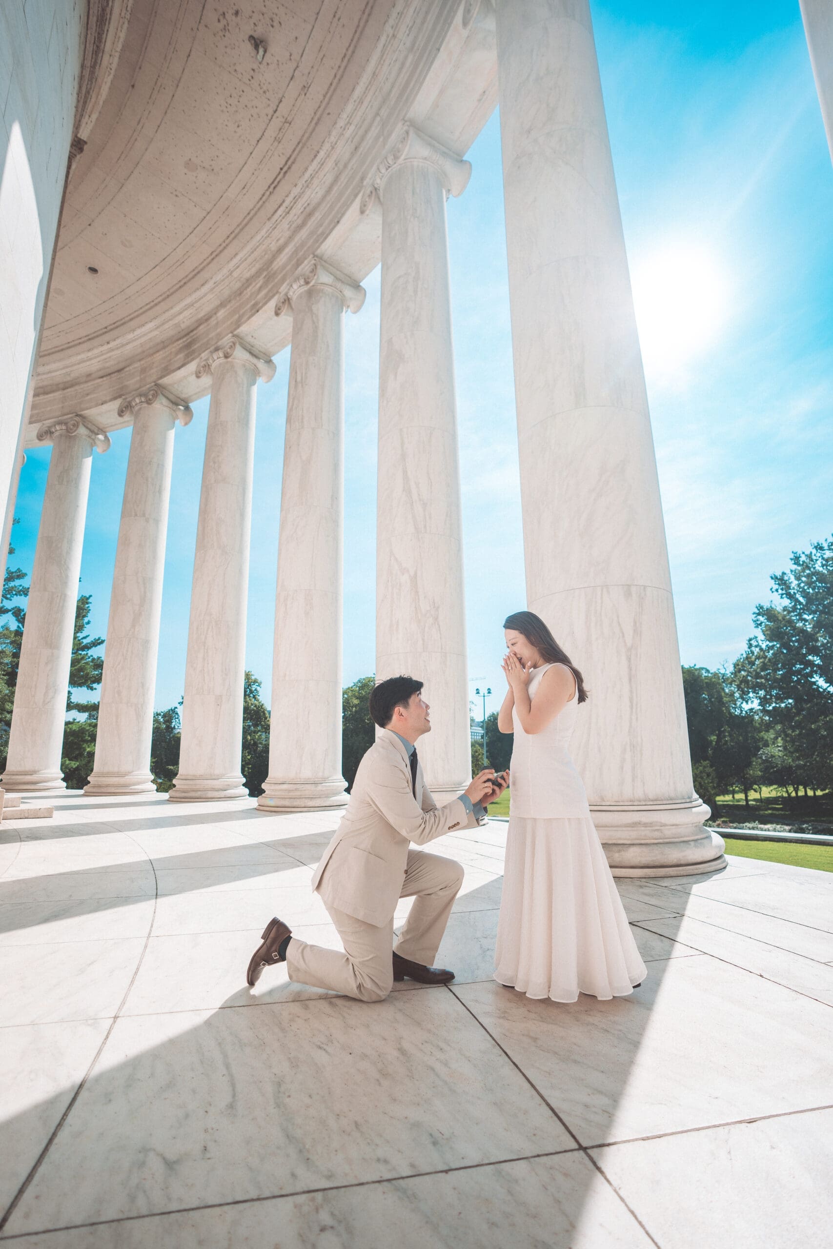 Surprise proposal at the Jefferson Memorial with partner kneeling beneath iconic marble columns in Washington DC