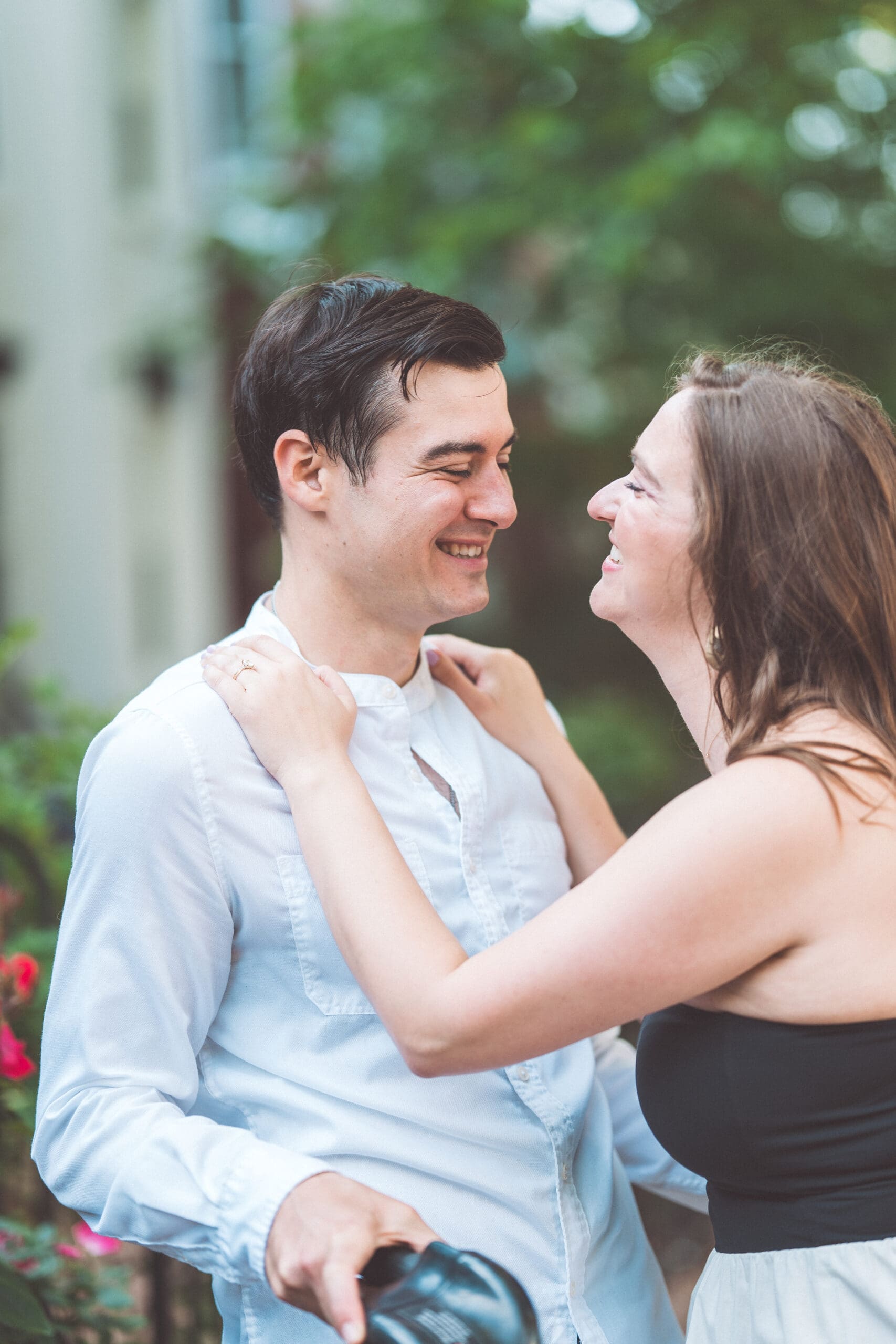 Close-up candid of an engaged couple smiling at each other during their DC engagement session