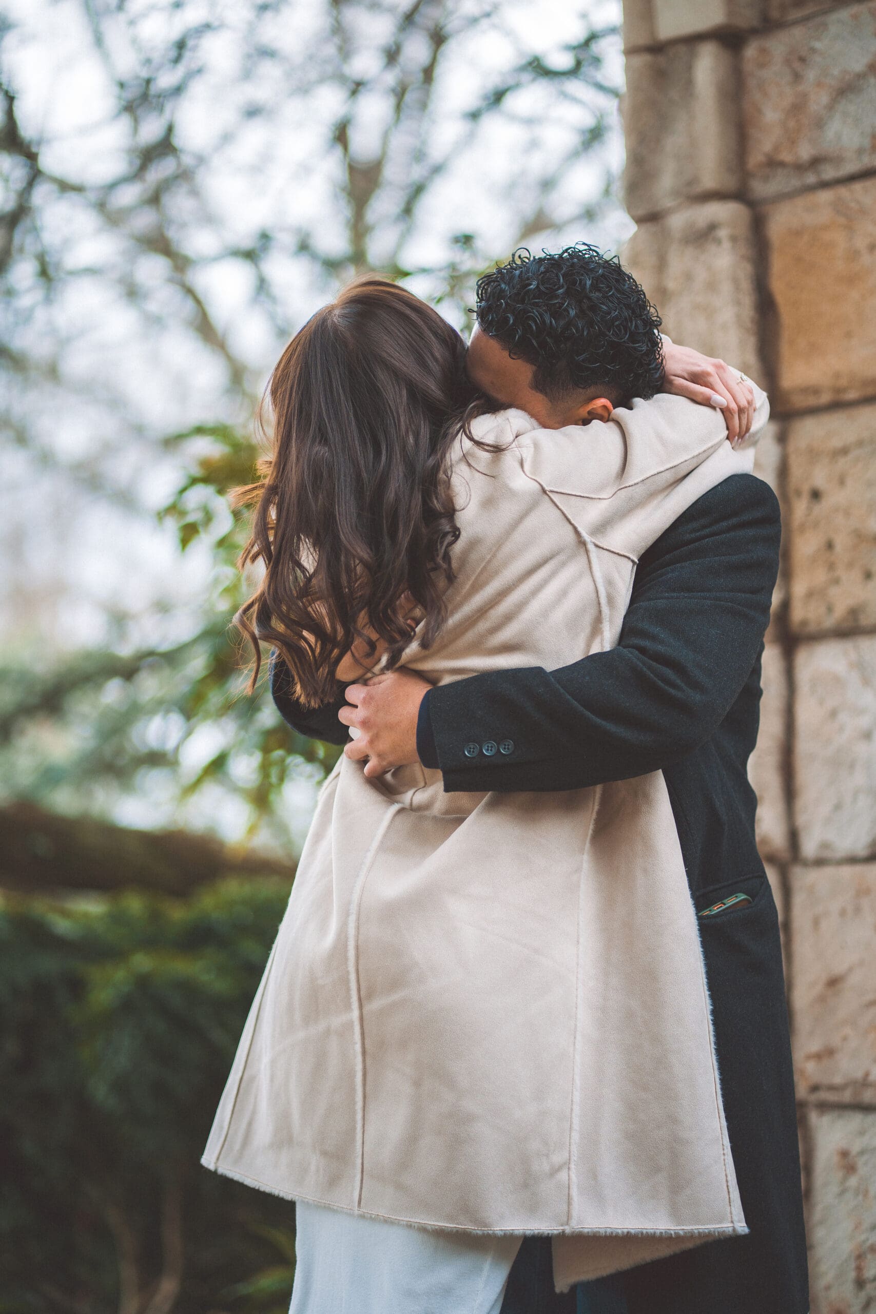 Couple sharing a kiss during their engagement session at Washington National Cathedral.