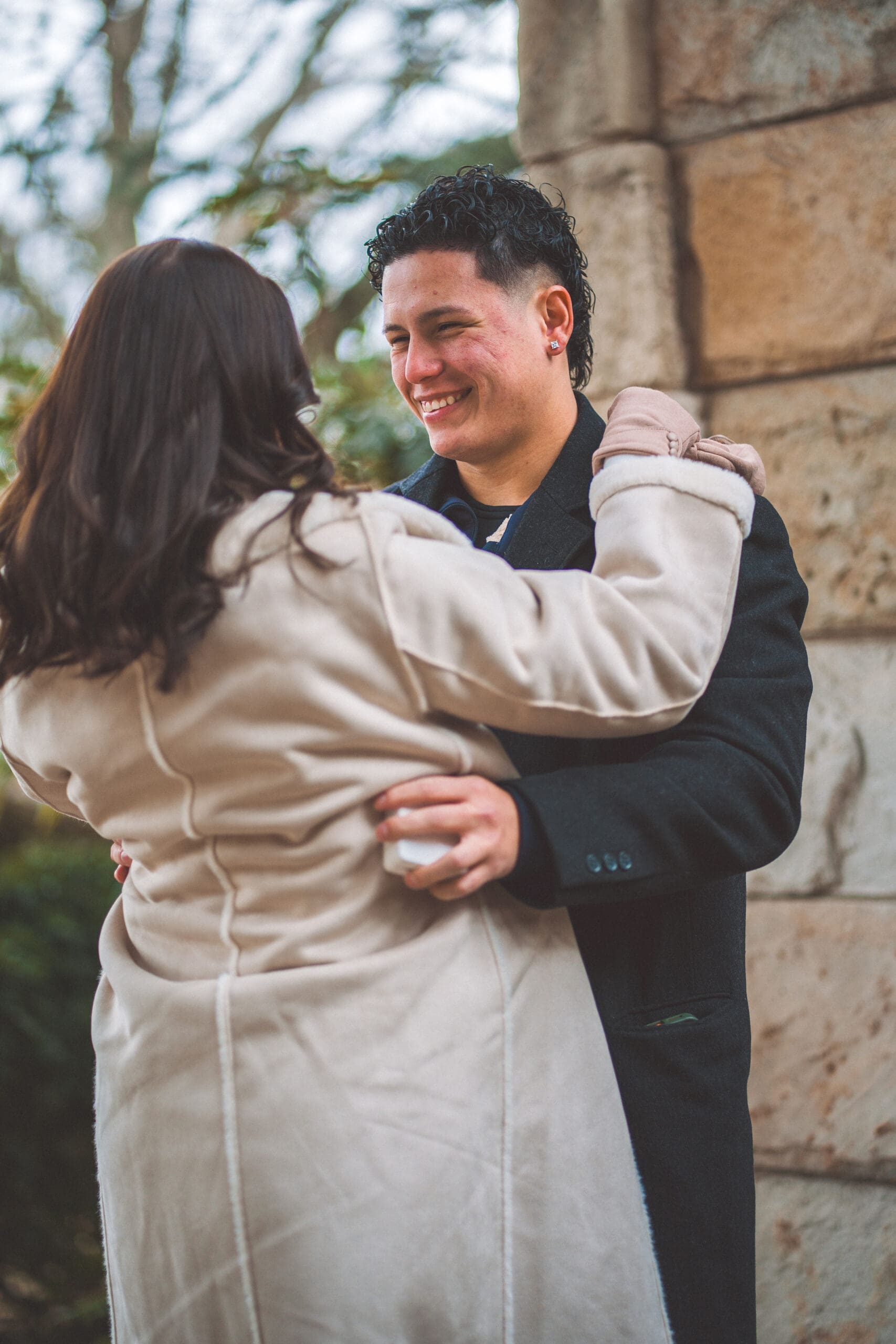 Washington DC proposal portrait of the couple embracing and celebrating their engagement at Washington National Cathedral.