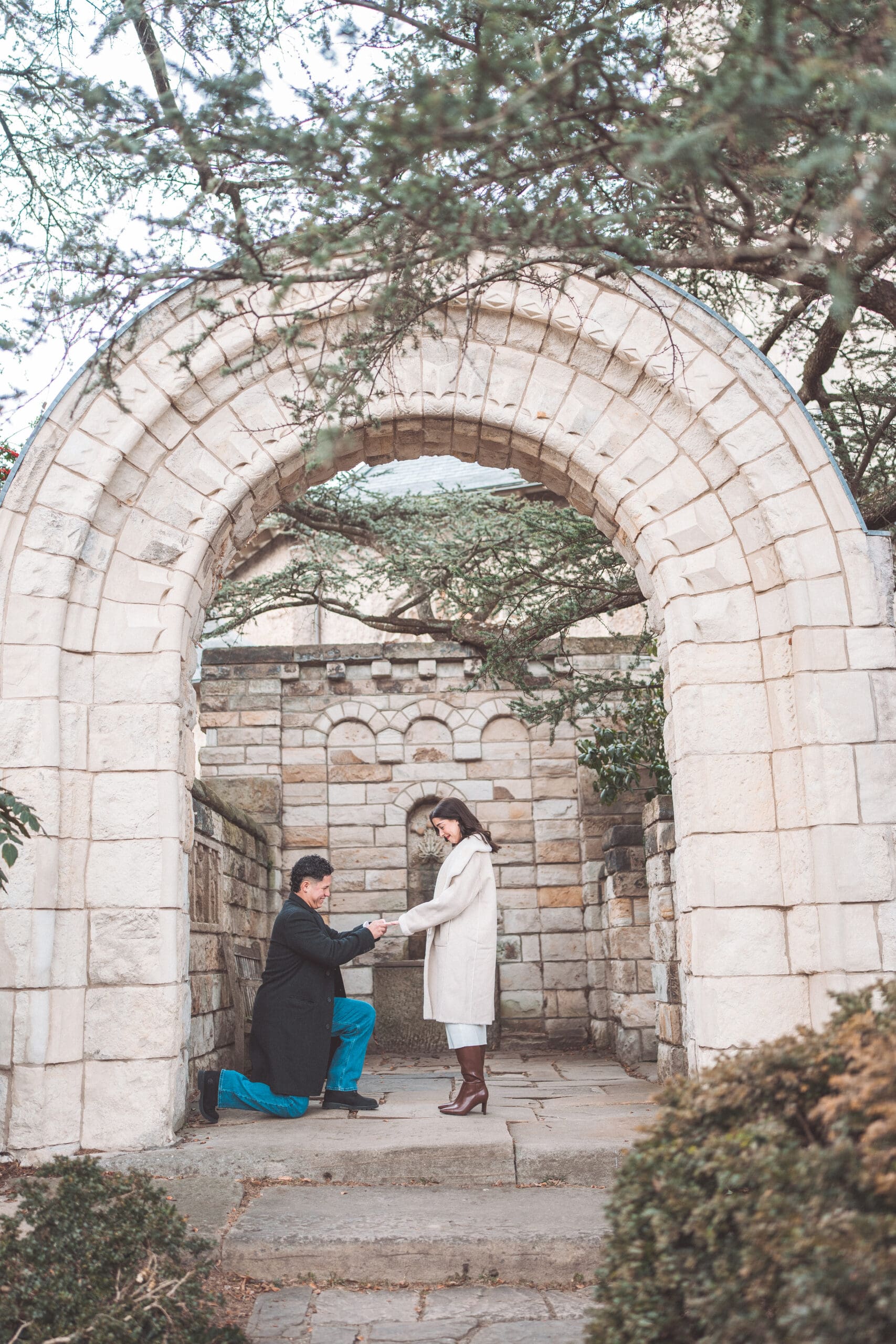 Washington DC proposal at Washington National Cathedral featuring a surprise engagement beneath a historic stone archway.