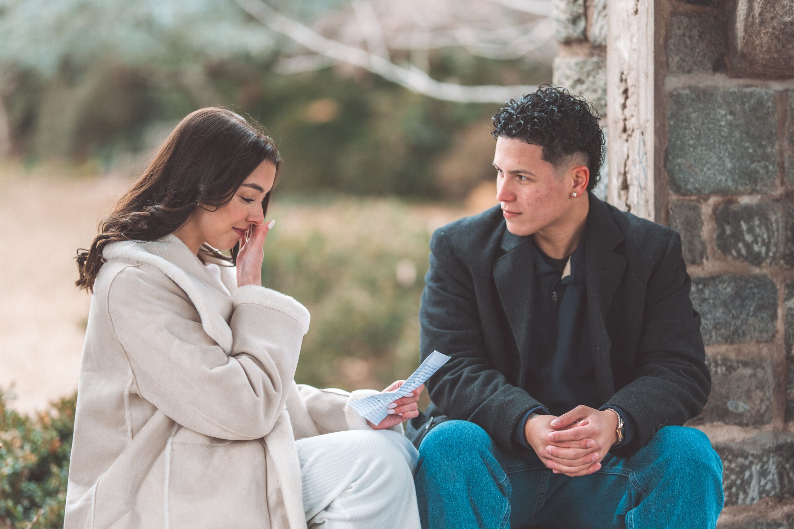 Newly engaged couple sharing a quiet moment together after reading personal letters at the cathedral.
