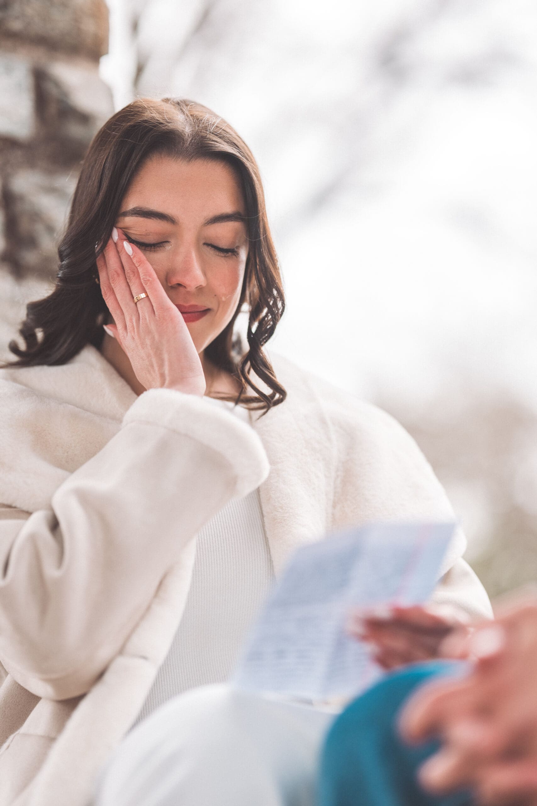 Bride-to-be reading a heartfelt letter before a surprise proposal at Washington National Cathedral.