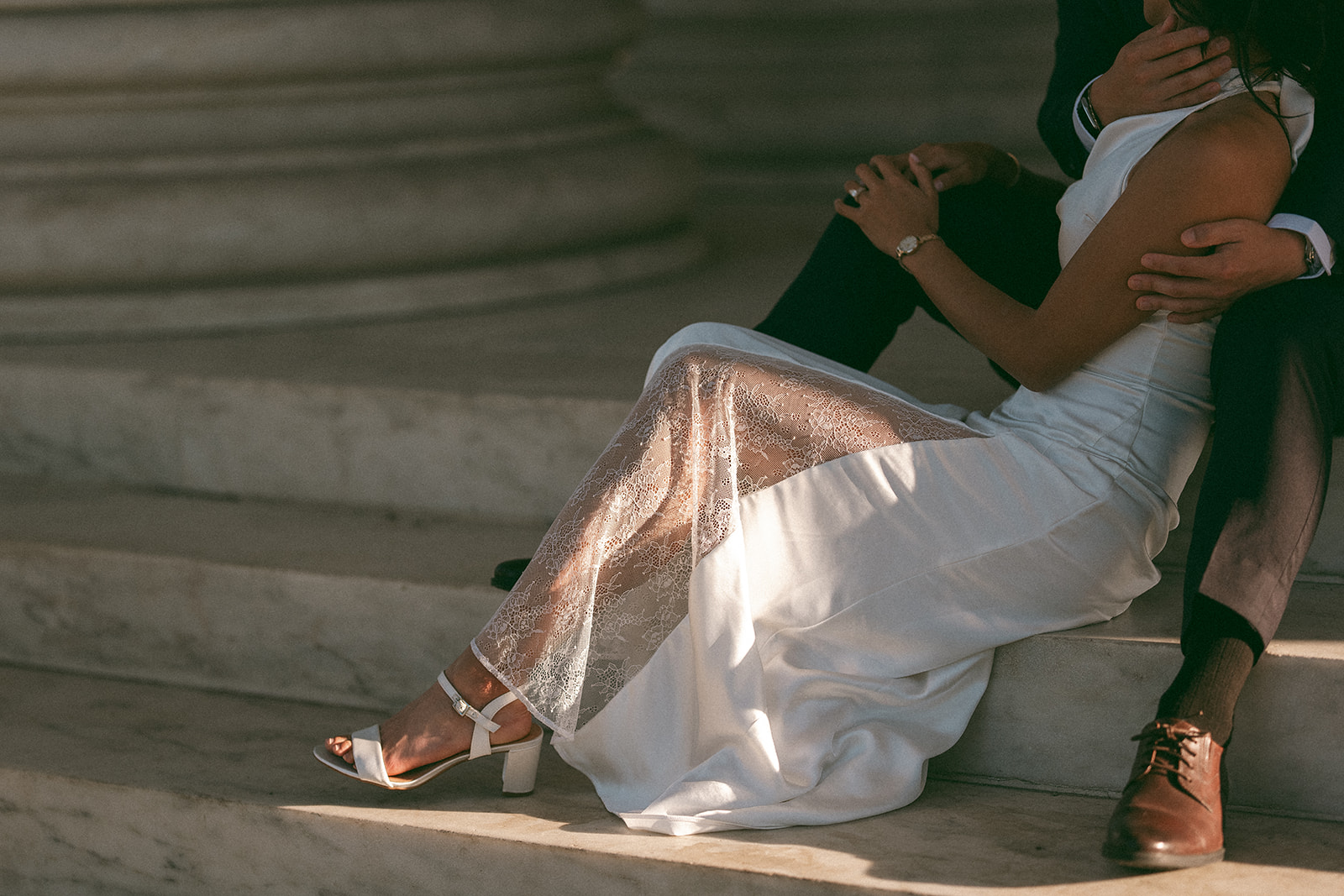 Close-up of the bride's dress and heels resting on the Jefferson Memorial steps.