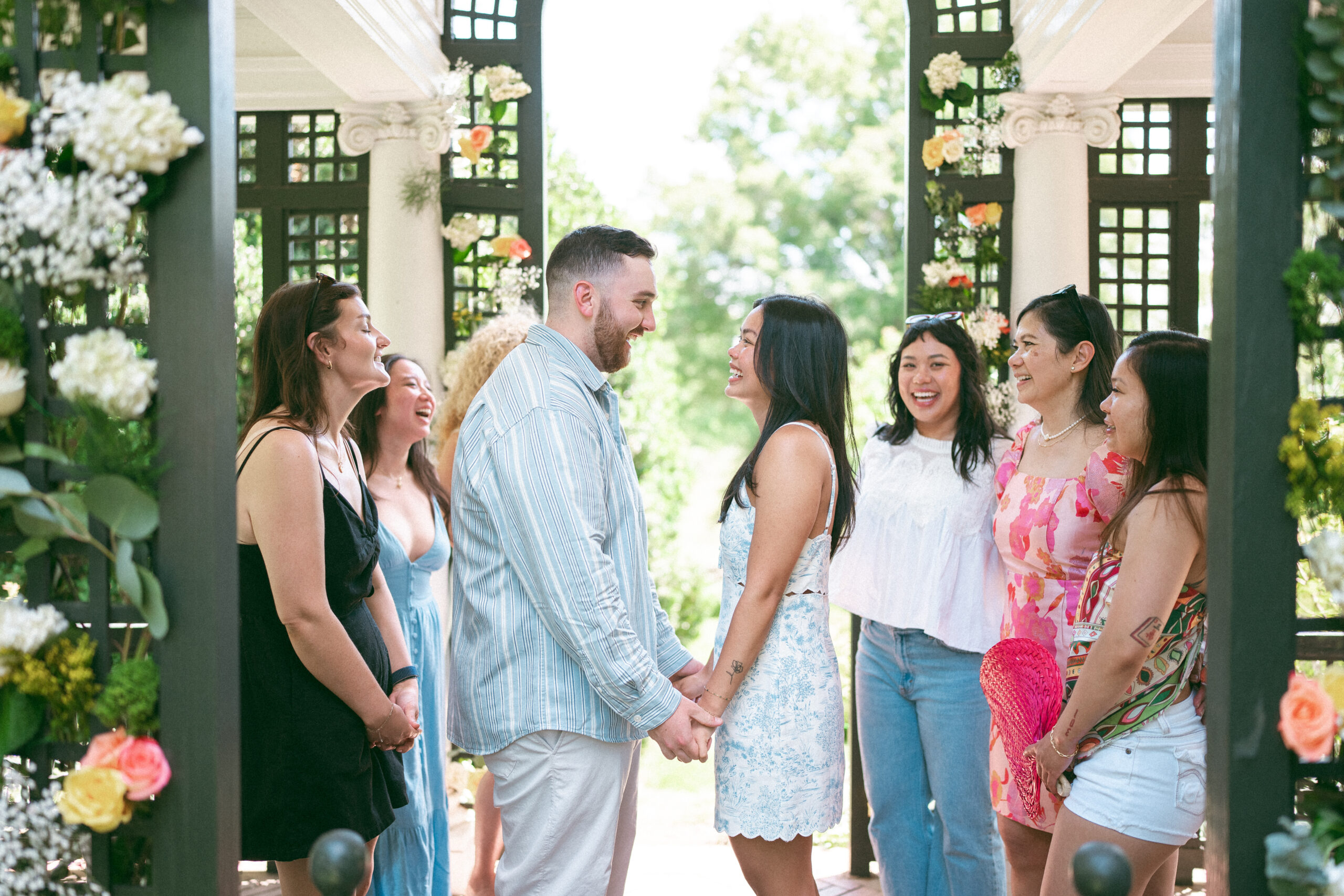 Newly engaged couple celebrating with family and friends after the proposal.