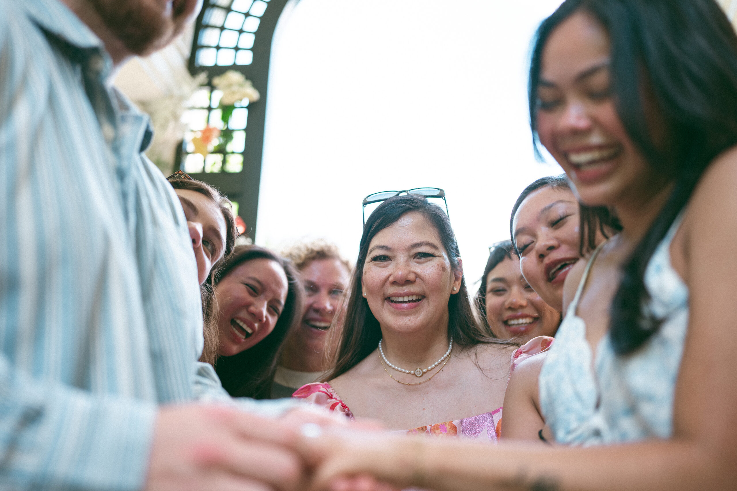 Family and friends gathering around the newly engaged couple after their Northern Virginia proposal.