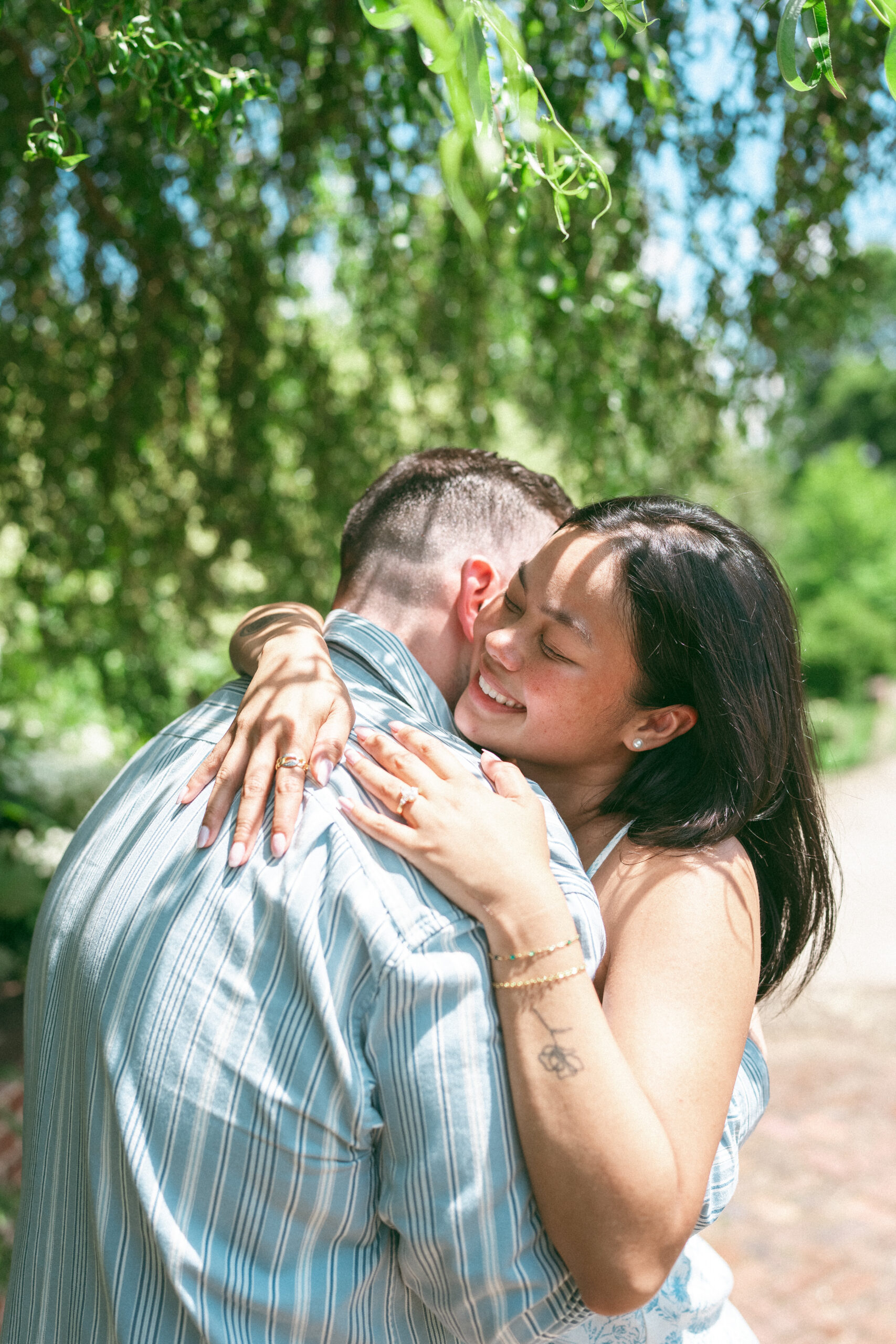 Couple sharing a heartfelt hug after celebrating their engagement.