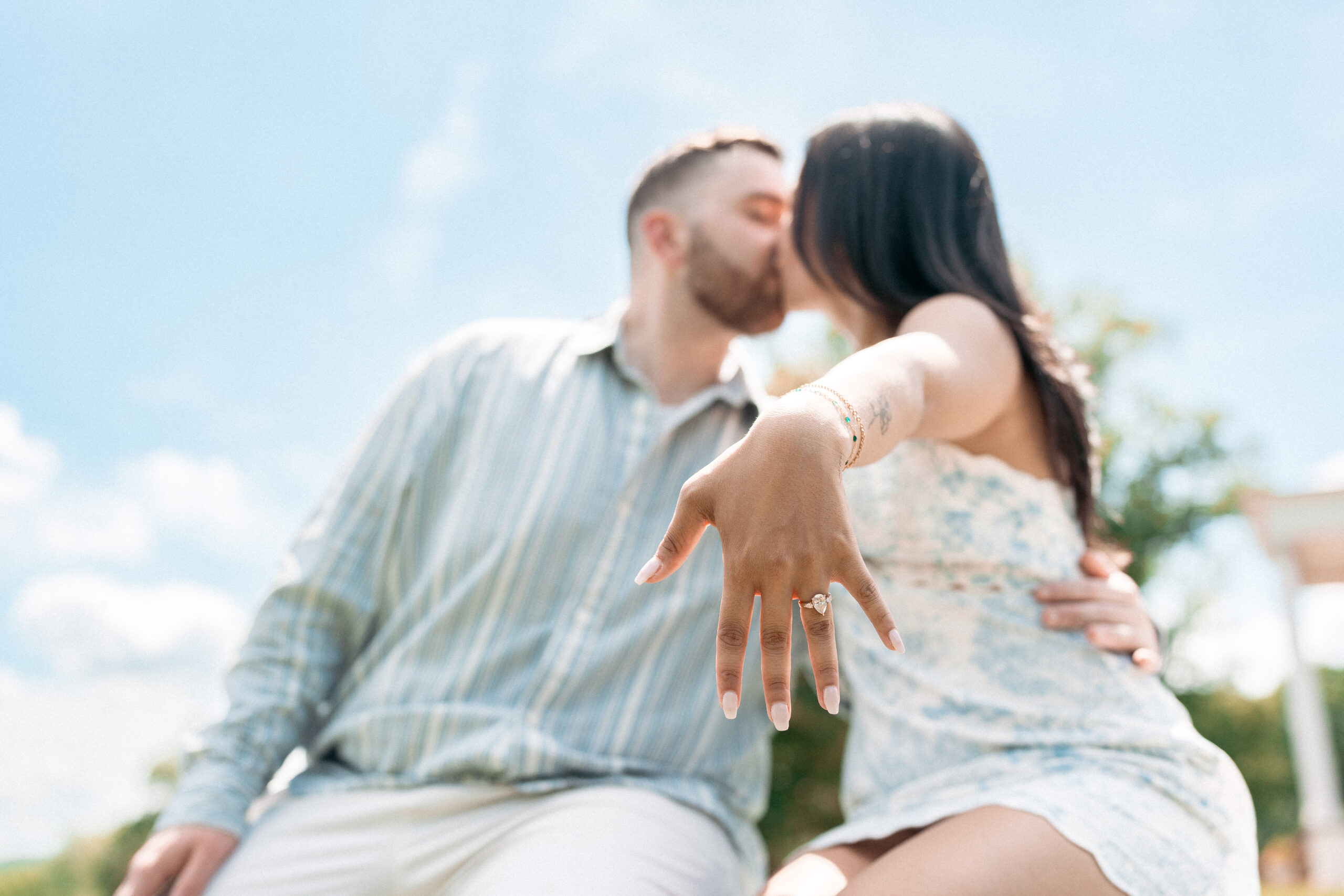 Close-up of a newly engaged couple kissing with the engagement ring in focus during a Northern Virginia proposal.