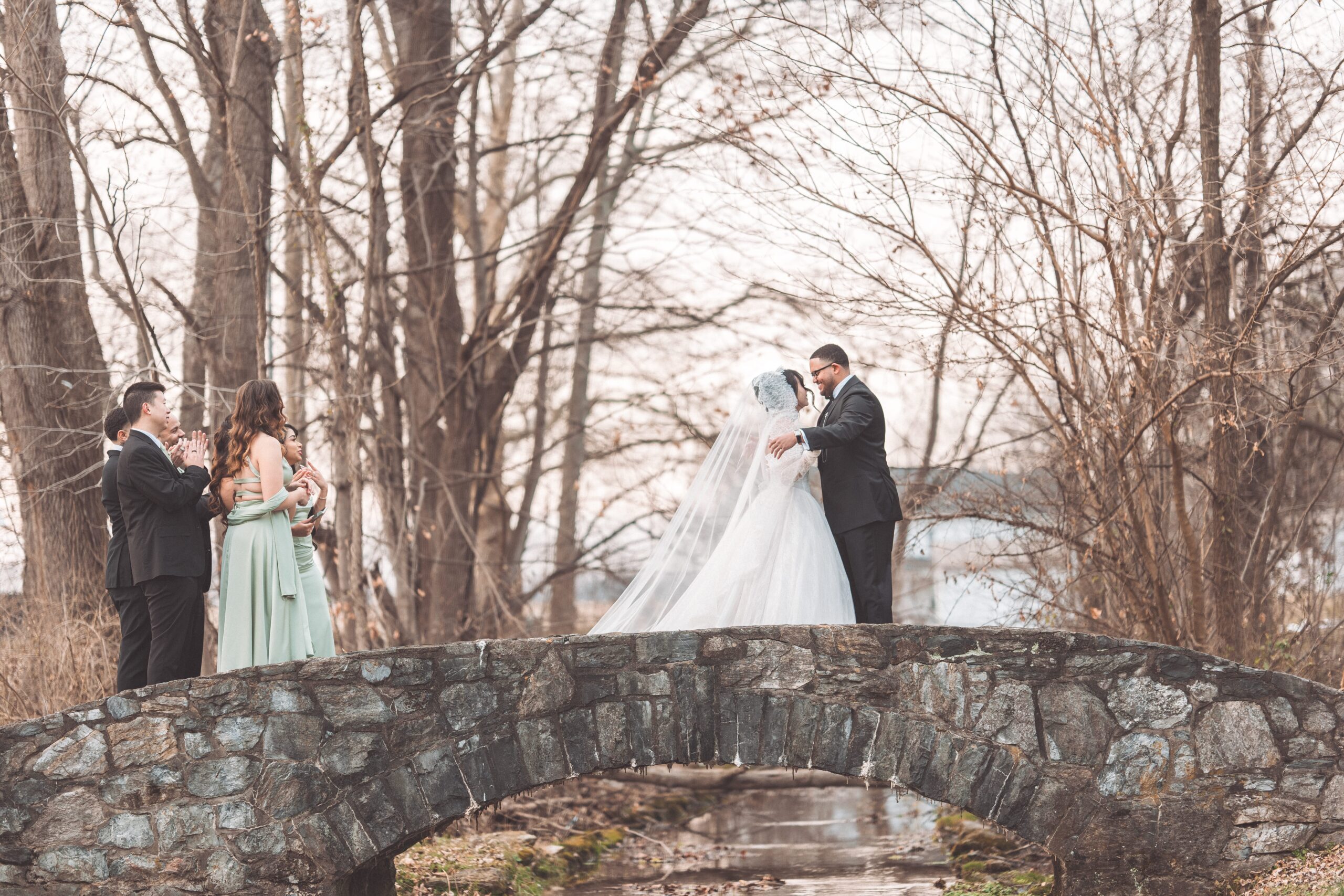 Bride and groom embracing after their first look on the stone bridge at Cameron Estate Inn.