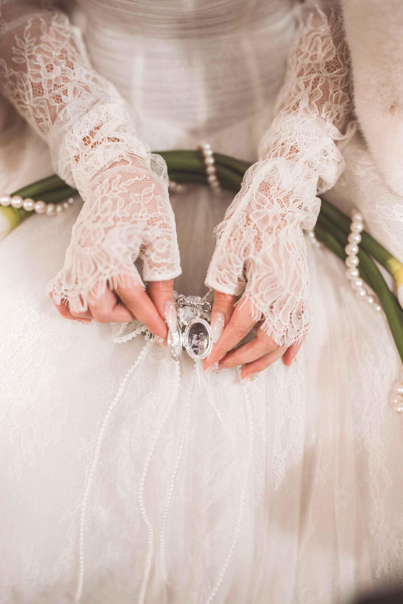 Up close shot of a brides grandmothers locket adorned in pearls.