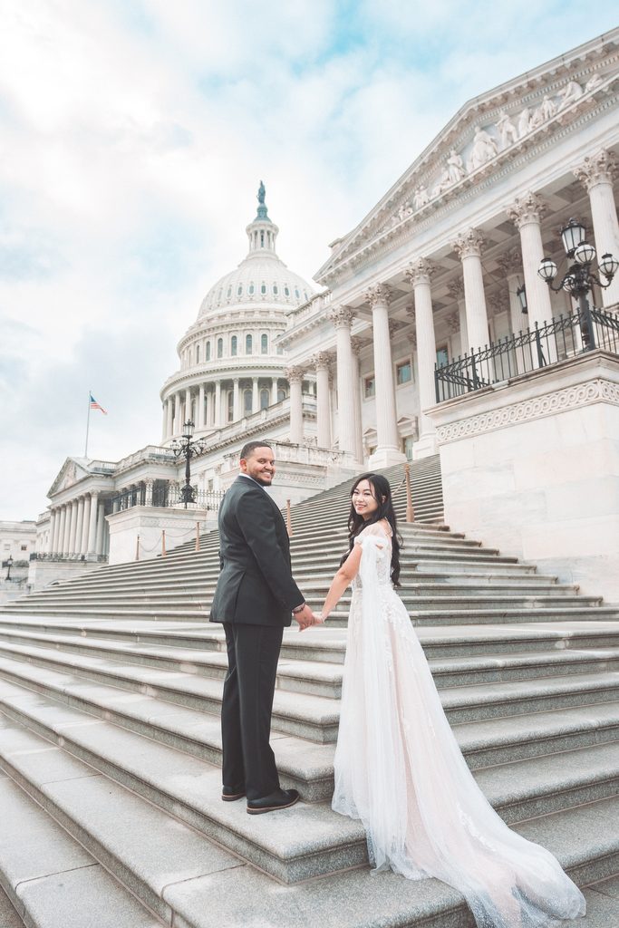 Couple holding hands on the U.S. Capitol steps during their Washington DC engagement session.