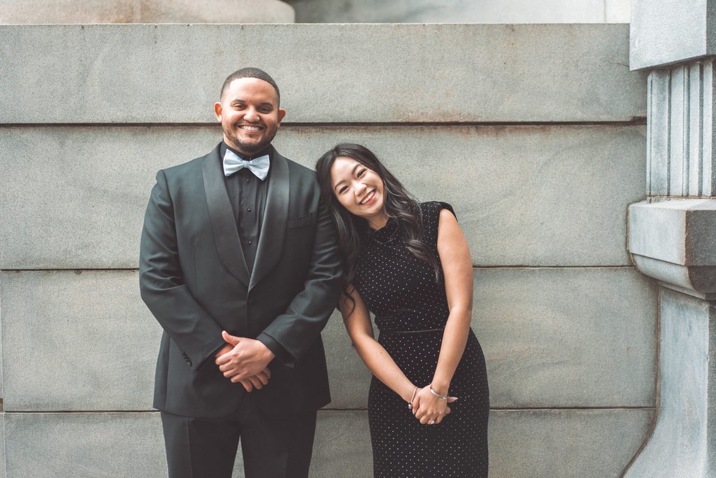 Wide engagement portrait of a couple together at the Jefferson Memorial in Washington DC.