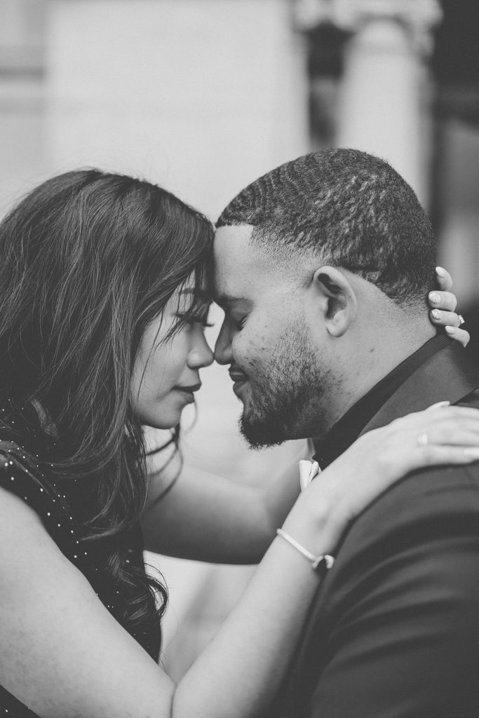 Black-and-white close-up of an engaged couple touching foreheads during their Jefferson Memorial engagement photos in Washington DC.
