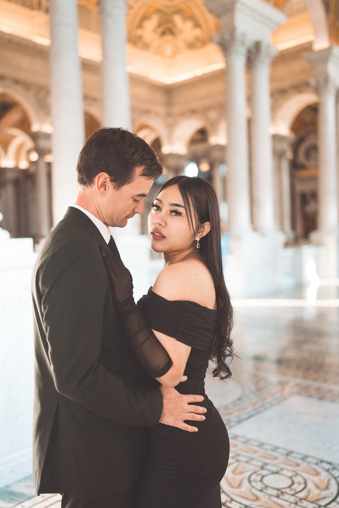 Romantic close-up engagement portrait of a couple embracing inside the Library of Congress.