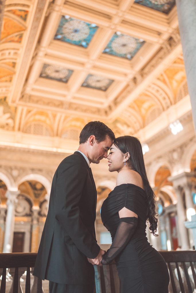 Romantic Library of Congress Engagement Photos of a couple touching foreheads beneath the ornate painted ceilings.