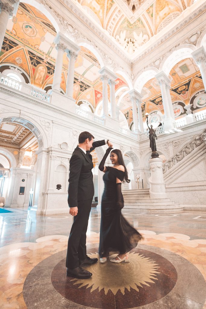 Couple dancing beneath the ornate ceilings during their Library of Congress Engagement Photos.