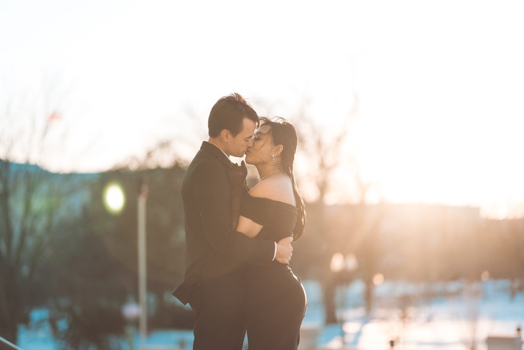 Couple kissing in warm sunset light during their engagement session in Washington DC.